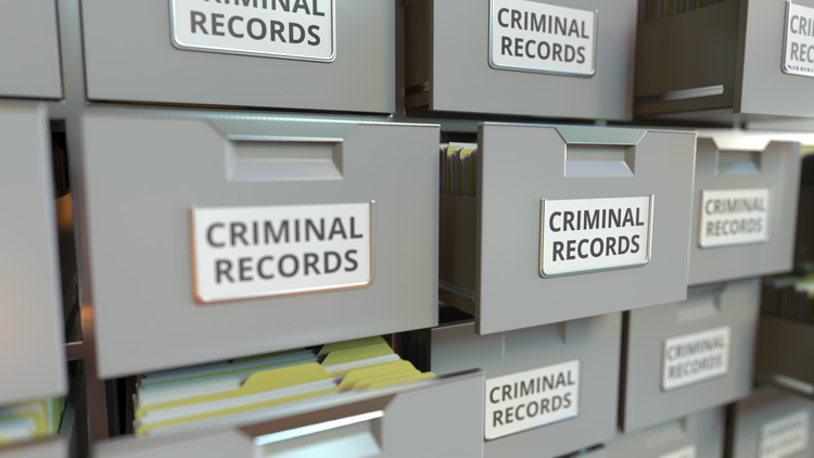 An image showing several filing cabinets labeled criminal records.
