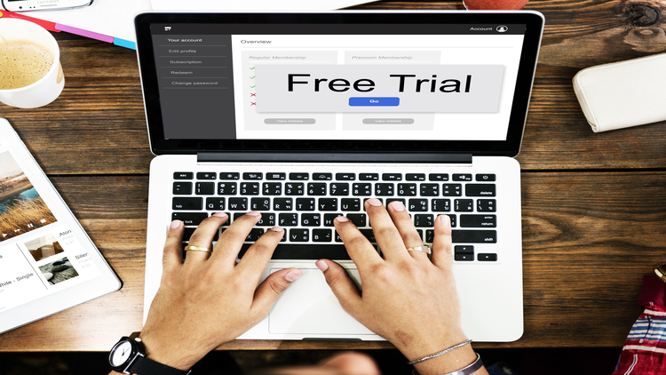 A person using a laptop to sign up for a free trial.