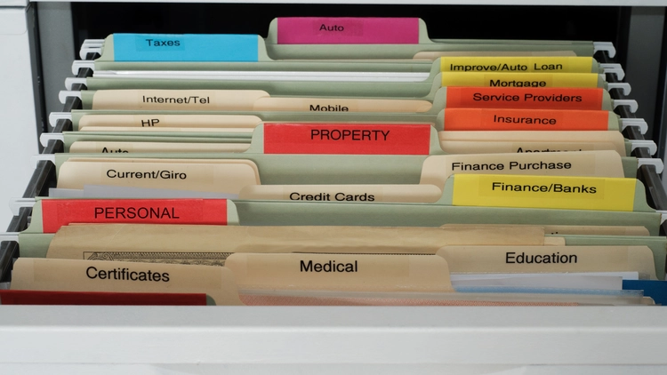 An organized file cabinet with labeled folders for various documents.