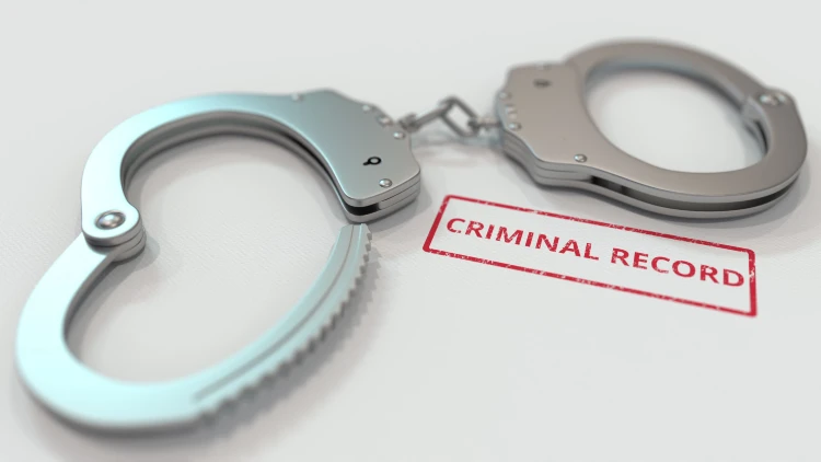 Close-up of handcuff with 'criminal record' stamped word on white background.