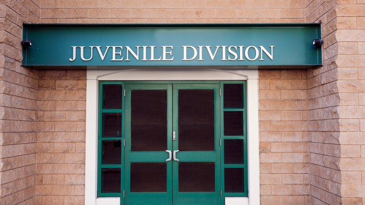 Entrance to the Juvenile Division building with a green sign above the door.