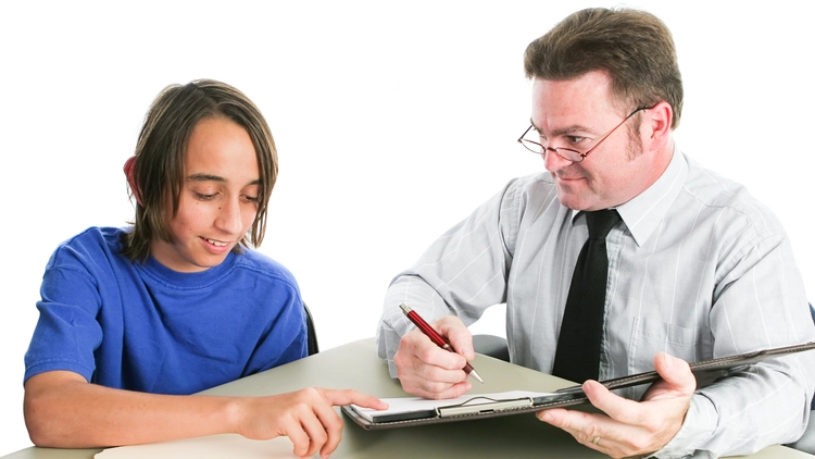Teenage boy consulting a lawyer to seal his juvenile records.