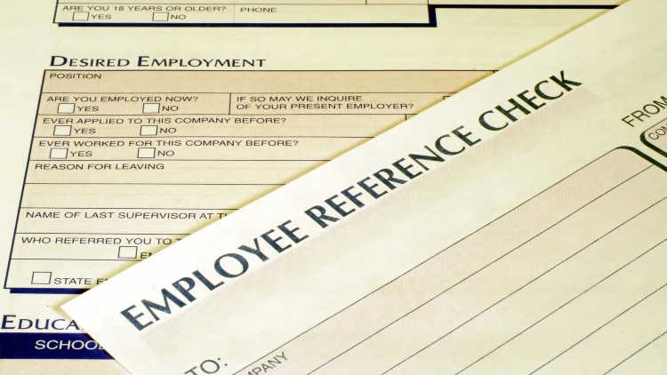 Close-up view of an employee reference check form.