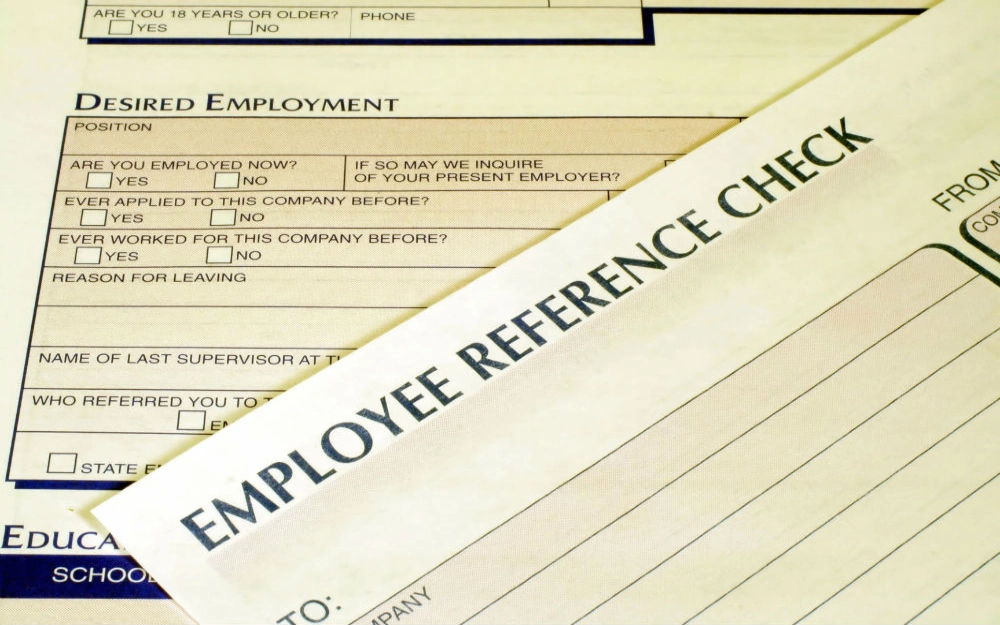 Employee reference check document showing a list of questions with check boxes on page 2 after employee has agreed to the cost of how much to pay for a background check on page 1.