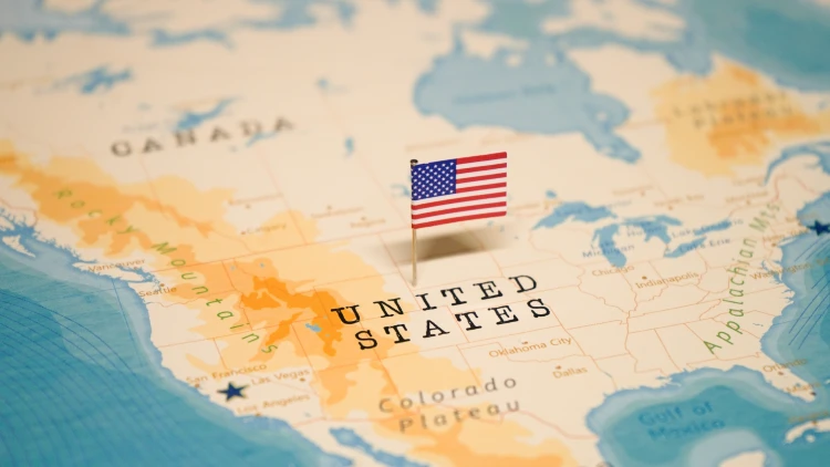 Close-up view of a map of the United States with a US flag pinned in the middle.