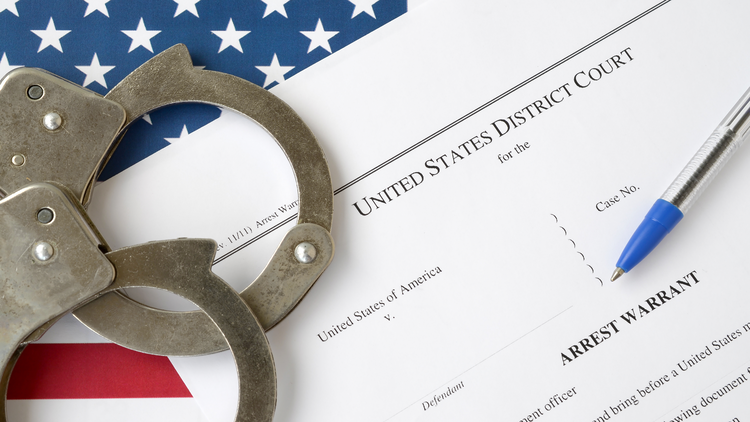 A United States District Court form titled "Arrest Warrant" shown next to handcuffs and an American flag.