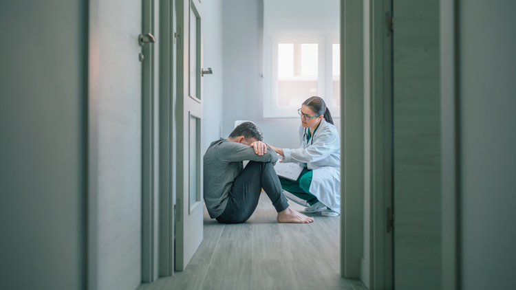 An image of a doctor assisting pa patient in a mental health facility.