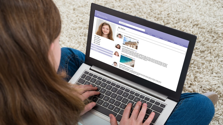 An image of a girl reviewing social media profile page.