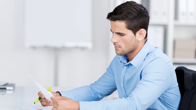 A person looking at a background check report thinking how long felonies stay on record.