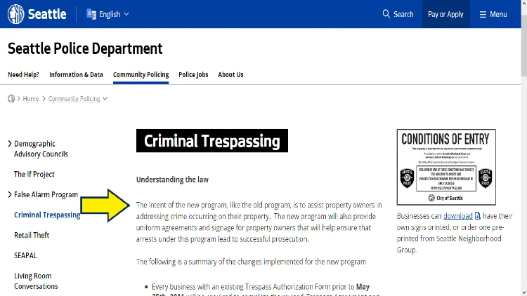 Screenshot of City of Seattle website page for false alarm program with yellow arrow pointing to criminal trespassing law in Seattle.