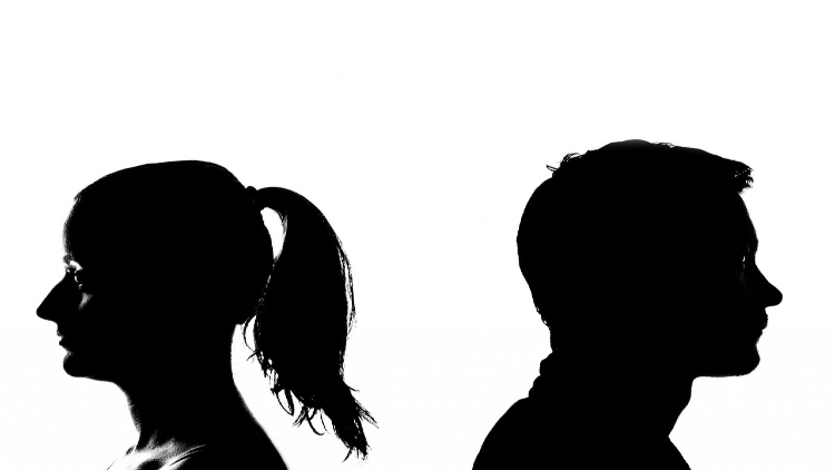 Black and white image of a couple's profile facing away each other