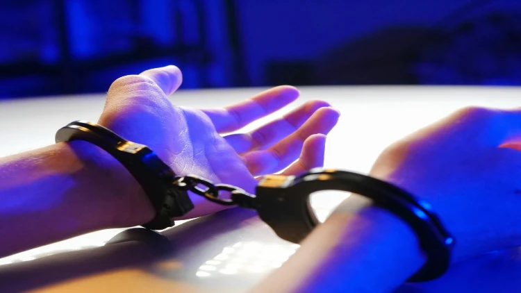 Close up picture of handcuffed open hands