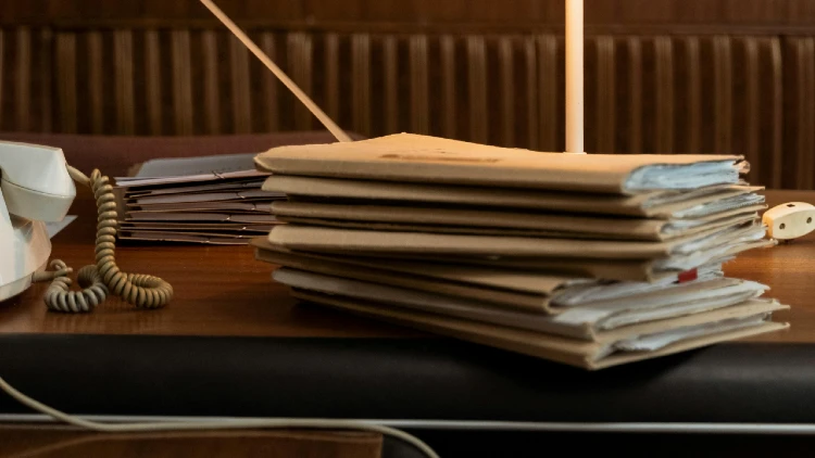 Close up image of stacked criminal records on top of a desk
