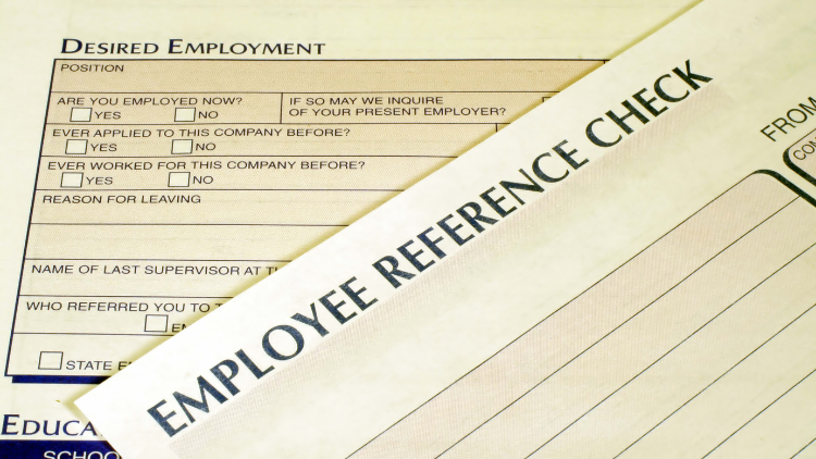 Close-up view of an employee reference check form.