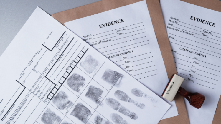 Top view of a fingerprint card and an evidence packaging envelope on a table.
